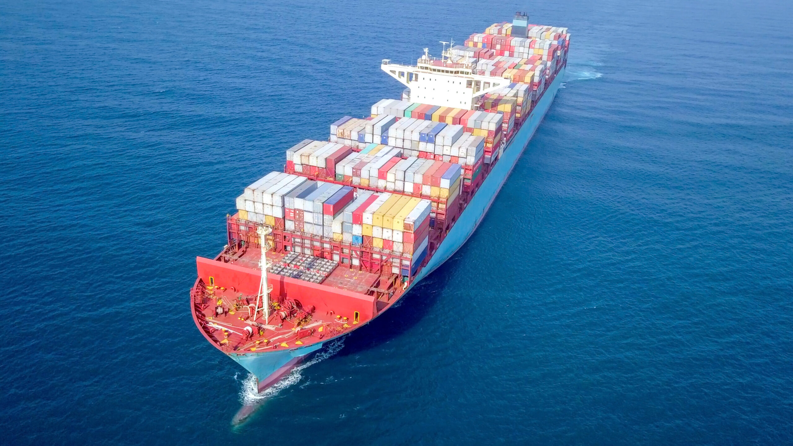 Large container ship at sea - Low angle aerial image.